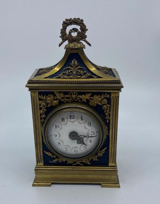 A small gilt French officers clock, having domed white enamel Arabic numeral dial, height 16cm.