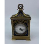 A small gilt French officers clock, having domed white enamel Arabic numeral dial, height 16cm.