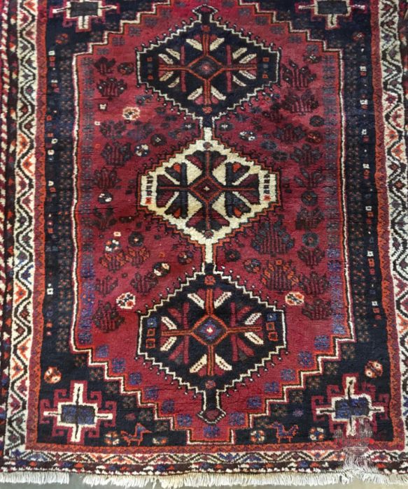 A small red rug (131 x 116cm) together with a small white rug (134cm x 68cm). (2)