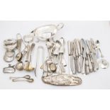 A collection of early 20th Century silver tea and condiments spoons and various bottle covers, all