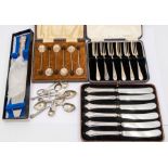 A collection of cased silver flatware to include: set of six coffee spoons with bean terminals, a