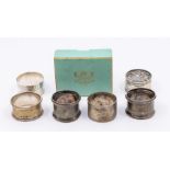 A collection of six 20th Century silver napkin rings, two engine turned, three engraved, one