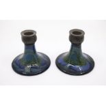 A pair of Moorcroft Moonlit Blue pattern squat candlesticks, circa 1920s, pewter tops, in the
