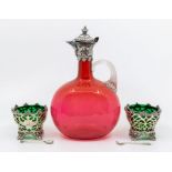 A late Victorian cranberry glass decanter with plated top and a pair of plated salts with green