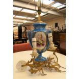 A large blue ceramic urn with gilt brass footed base and fitted lamp to top, gilding and portrait,