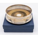 A Modern silver reticulated wine coaster, turned wooden base, hallmarked by Douglas Pell Silverware,