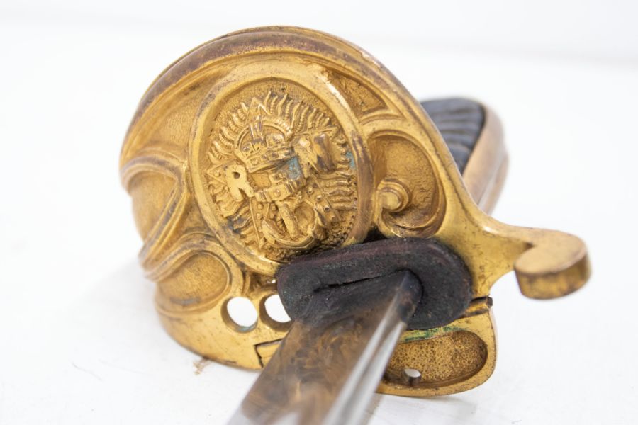 A vintage Royal Navy style sword. Gilt brass hilt with the Royal Marines badge and folding locking - Image 3 of 5