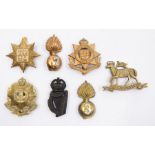 A selection of British Regimental cap badges including a Tenth County of London Battalion (Hackney