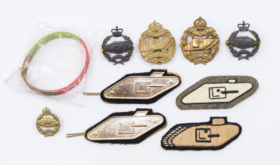 A selection of Royal Tank Corps badges, including a WWI lugged example brass, a WWII brass example