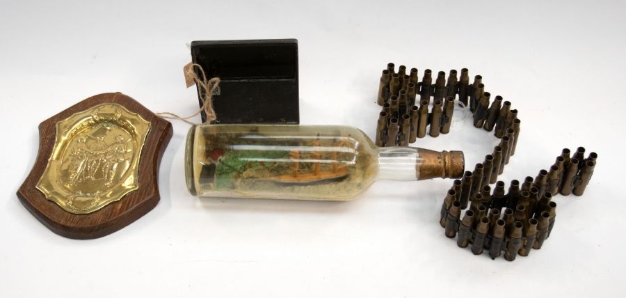 A selection of military related items including an interesting ship in a bottle model (good