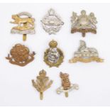 A selection of WWI / WWII and later British cap badges, including a bi metal Royal Lincolnshire