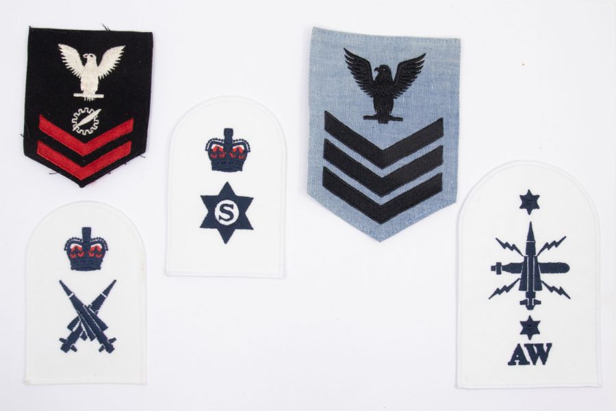 A selection of embroidered and Bullion Military Insignia including an Irish Guards Colour