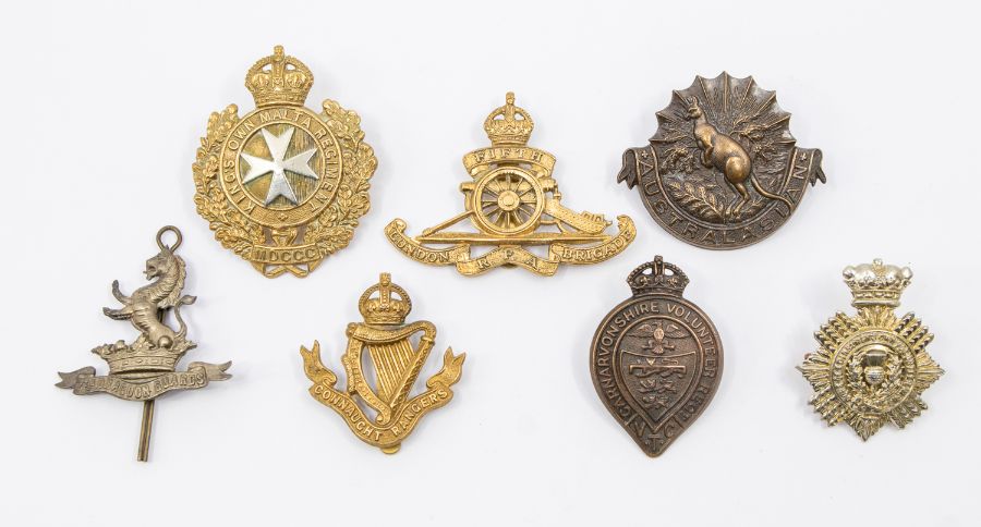 A collection of seven Regimental cap badges including a bronze Australasian Squadron example, a