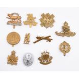 A selection of British cap badges including a Leicestershire Regiment bi metal badge on slider,