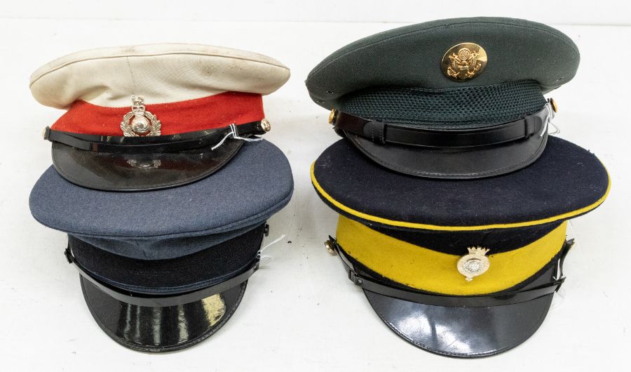 A collection of four militaria caps including; a Royal Marines cap, fitted with QEII Crown badge (