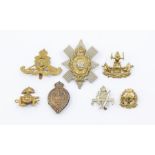 A selection of British badges including other ranks die stamped brass Royal Artillery cap badge on