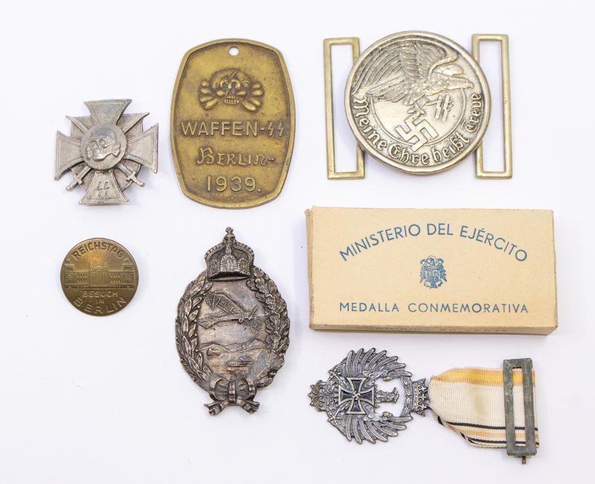 A selection of reproduction/Post-War medals/badges, to include: a Waffen SS brass tag; an SS belt