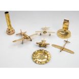 A small collection of trench art style brass pieces, including four models of WWII era planes of