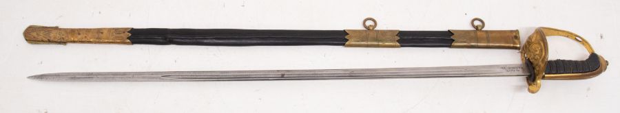 A vintage Royal Navy style sword. Gilt brass hilt with the Royal Marines badge and folding locking