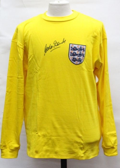 England: A signed replica yellow England goalkeeper shirt, signed by Gordon Banks.