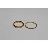 A pair of wedding bands, one hallmarked 22ct gold (approximate weight 3.4gm) and a second yellow
