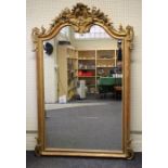 A large Victorian carved giltwood and gesso overmantle mirror in the Rococo manner, the pierced,