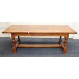 A good reproduction oak refectory dining table, the planked, cleated rectangular top on baluster