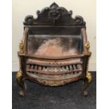 A small late 19th century French cast iron and brass fire basket with raised back, serpentine front,