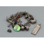 A selection of silver jewellery comprising a charm bracelet including a sputnik charm, containing