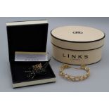 An 18carat gold, “Watch Over Me” cuff bracelet with cross-over safety chain by Links of London,