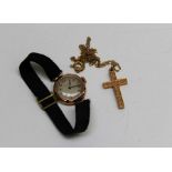 A 9ct gold ladies wristwatch (un tested) along with a 9ct gold ornate engraved cross, marked for