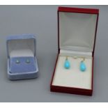 A pair of round opal cabochon ear studs set in yellow metal marked 14k and a pair of shepherd’s