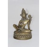 An early 20th century cast gilt bronze Buddha with lotus flower and raised right palm, 31cm high