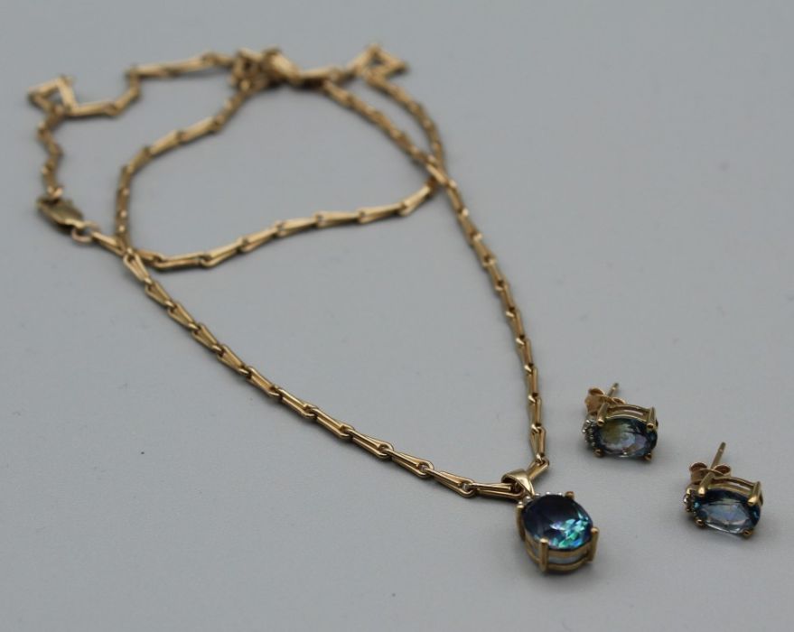 An oval cut mystic topaz  single stone pendant, suspended from a 9ct gold chain, together with a