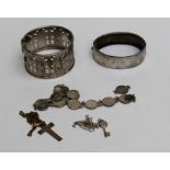 A selection of silver jewellery comprising two pendants, two bangles and a coin bracelet