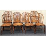 A set of eight reproduction elm Windsor chairs, each having hoop and stick back, saddle seat,