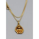 A hallmarked 18ct gold Spiga chain with a yellow metal hollow floral pendant