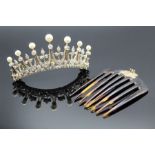 A diamond and natural pearl tiara on a tortoiseshell comb, in fitted case. Featuring seven off round
