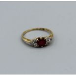 A diamond and ruby ring in 18ct gold, size N 1/2