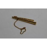 A 9ct gold bar tie pin with safety chain. approximate weight 3.6gm