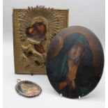 A 19th century Russian icon, written with The Holy Mother and Christ beneath a worked brass mount,