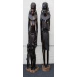 A pair of 20th century well carved ebony figures of a Maasai Warrior, his wife and two children.