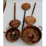Two circular copper preserving pans, three watering cans and three copper warming pans