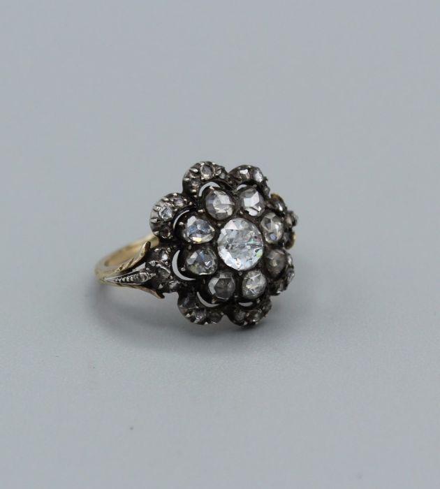 A Georgian diamond set cluster ring, set with thirty rose cut diamonds, with the principal stone