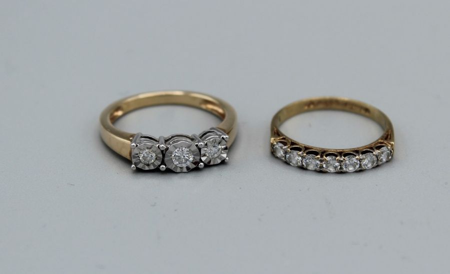 A 9ct gold diamond illusion set ring, plus a cubic zirconia half hoop ring in 9ct gold. Total