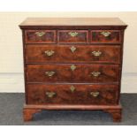 A George III figured walnut, crossbanded and strung chest, the rectangular top over three short