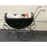 An Edwardian painted metal framed and upholstered dolls pram raised on spoked metal wheels, width