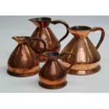 A set of four copper measures, largest height 31.5cm