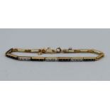 A diamond and sapphire gold bracelet (tested as 18carat), consisting of four panels of four,