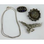 A marcasite set silver eagle brooch, two further silver brooches and a silver chain.